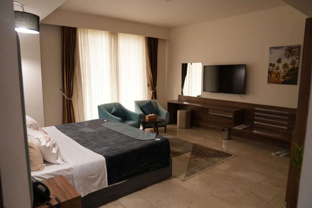 Khawarnaq Palace Hotel - King Bed Room with Seating for Two with Jacuzzi Bath with Large Lounge with Dining Table with 10 Person Seating Room Twin Beds with Private Bathroom