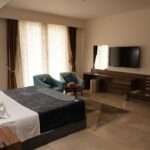 Khawarnaq Palace Hotel - King Bed Room with Seating for Two with Jacuzzi Bath with Large Lounge with Dining Table with 10 Person Seating Room Twin Beds with Private Bathroom